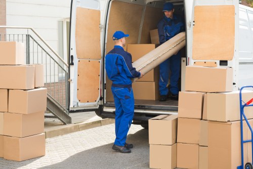 Removal team carefully handling furniture during a safe house move in Barnet
