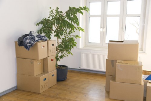 Trained movers using PPE while lifting furniture carefully