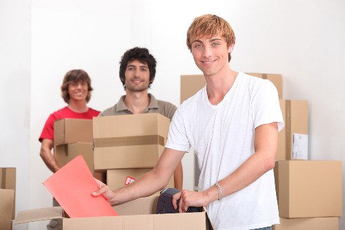 Movers handling desks and office furniture in a Barnet commercial building